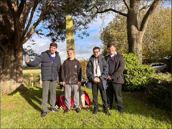 Four Milestone students are pictured visiting a War Memorial in Ash on Remembrance Day 2022.