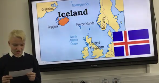 A student stood next to a board which shows a map of Iceland and their flag