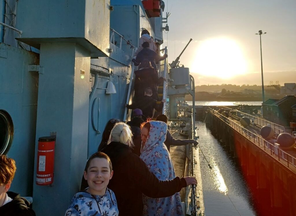 Milestone Academy students are pictured walking along the deck of a WWII warship, HMS Cavalier, during a school trip to Chatham Dockyard.