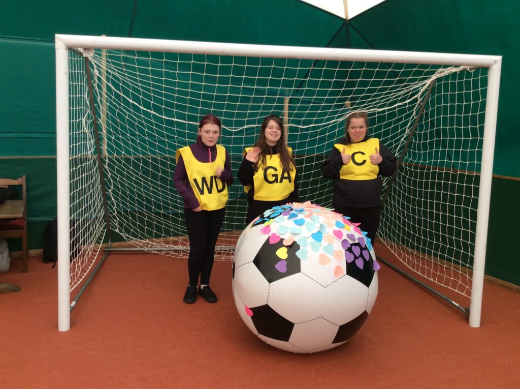 Three Students stood in a goal